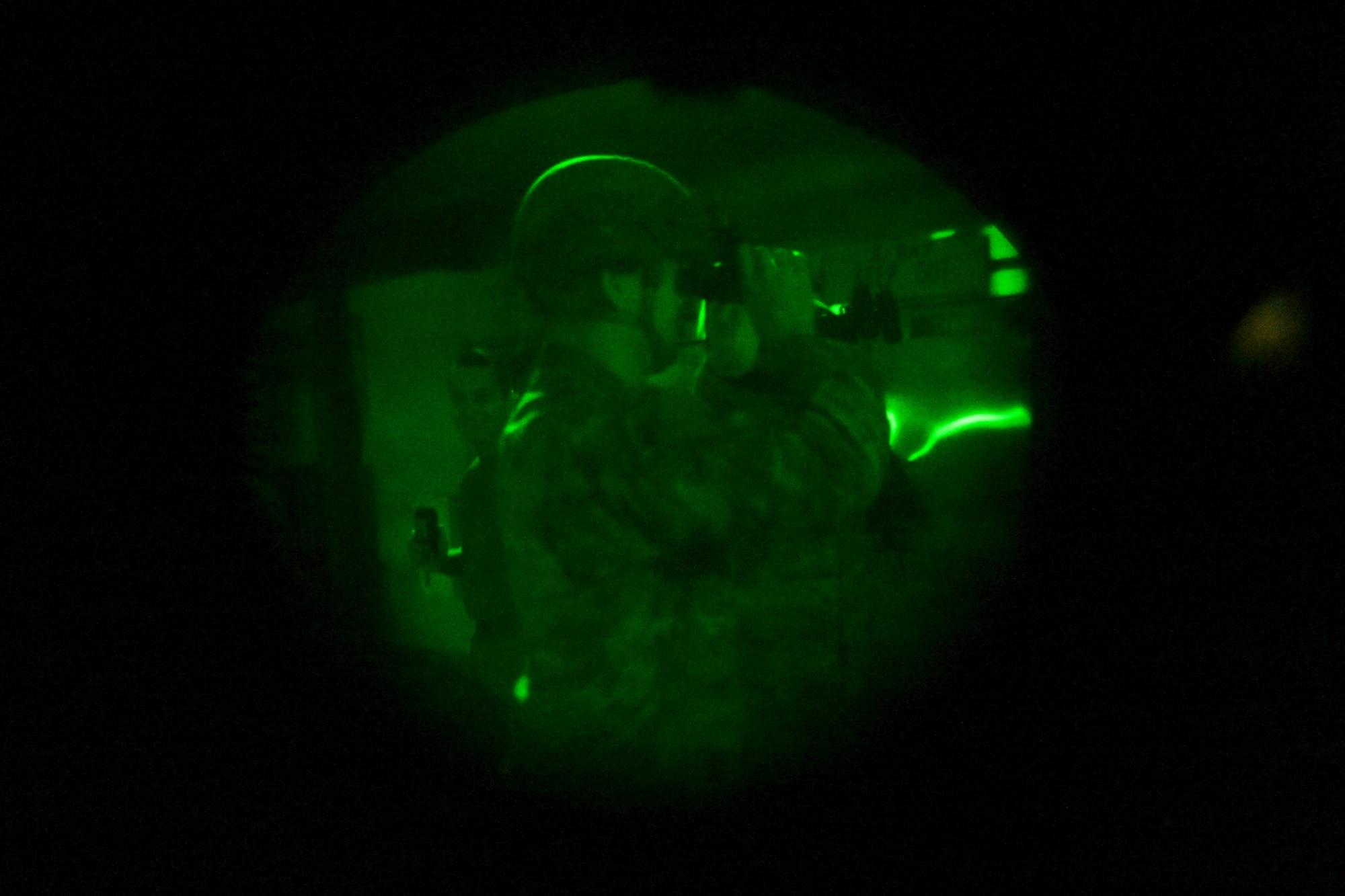 An Airman uses night vision goggles.