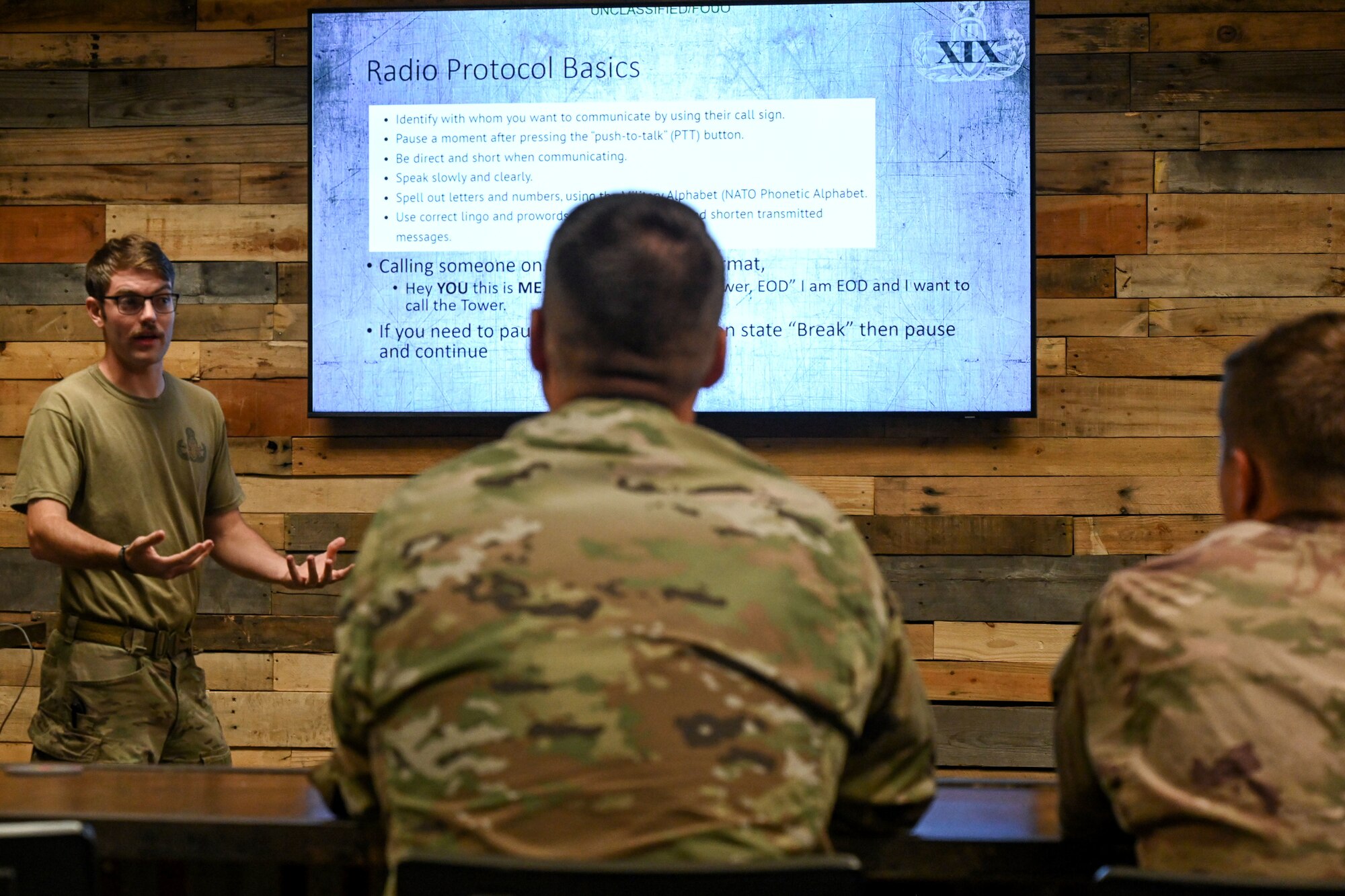 An instructor teaches a class to Airmen.