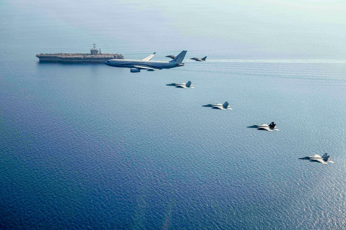 F/A-18E Super Hornets from Carrier Air Wing (CVW) 1 fly in formation with a French air force Airbus A330 MRTT and two Rafale F-3Rs alongside USS Harry S. Truman (CVN 75).
