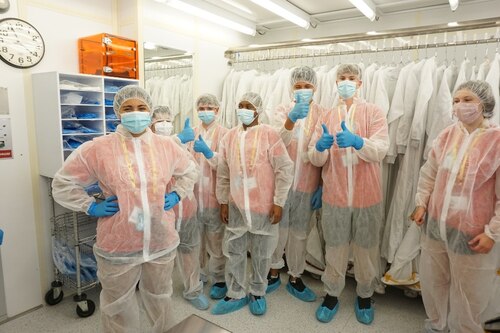 Air Camp students gown up to take a tour of the class 100 clean room at the Air Force Research Laboratory, or AFRL, Sensors Directorate facility at Wright-Patterson Air Force Base, Ohio. The students learned about science, technology, engineering and math, or STEM, careers within AFRL during their tour. Air Camp is a non-profit organization created to inspire students to pursue STEM education and career opportunities focused on aviation, aeronautics and increasing students' confidence to pursue a STEM career field. (Courtesy Photo)