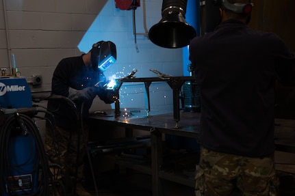 An Oklahoma Army National Guardsman with Company B, 700th Brigade Support Battalion, 45th Infantry Brigade Combat Team, welds to enhance their allied trade skill during their annual training at Camp Dodge Joint Maneuver Training Center near Johnston City, Iowa, July 18, 2022. The Sustainment Training Center provides individualized unit training in a culminating training environment. (Oklahoma National Guard photo by Spc. Danielle Rayon)