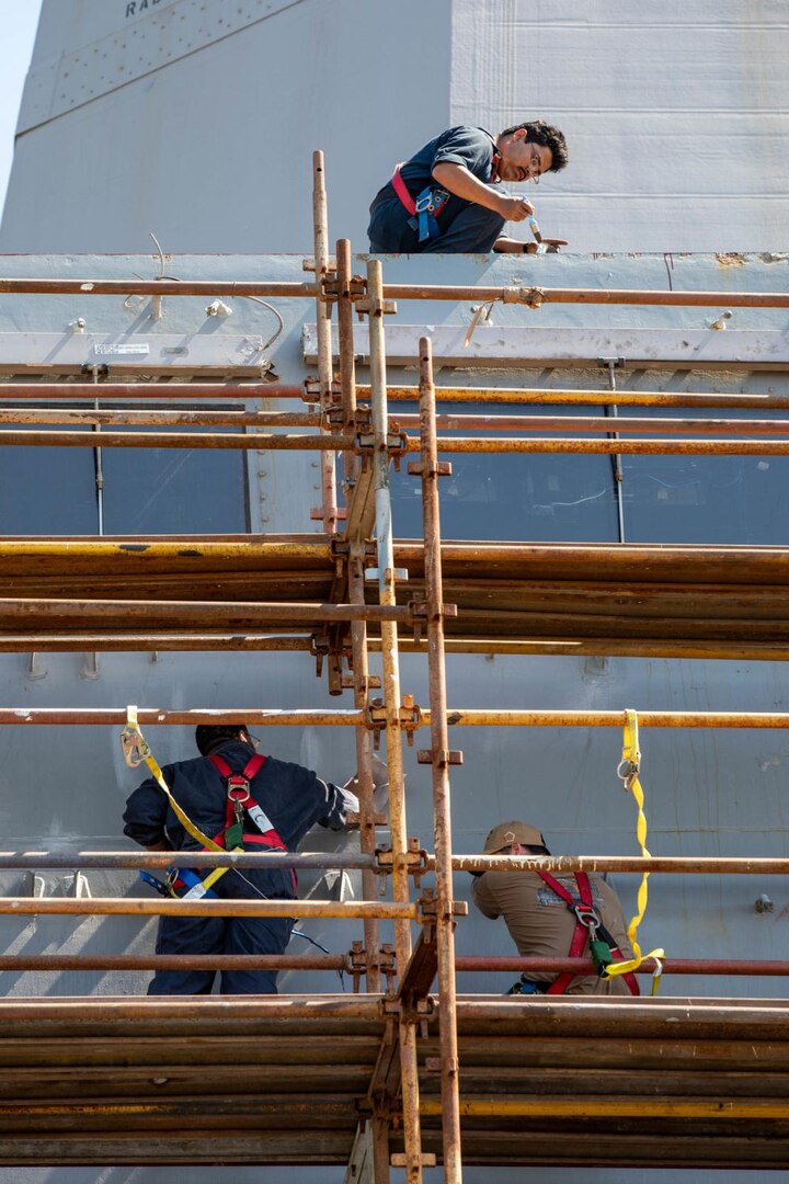 Sailors assigned to the San Antonio-class amphibious transport dock ship USS Arlington (LPD 24) sand and paint the exterior surface of Arlington’s pilot house during preservation work for mid-deployment voyage repairs in Rijeka, Croatia, July 6, 2022.