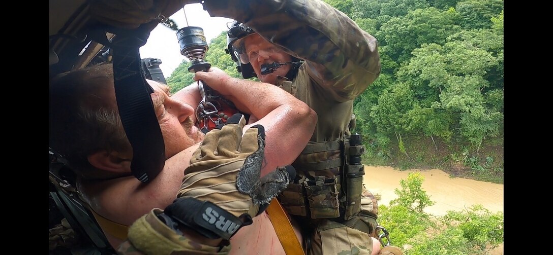 Kentucky Army National Guard's Detachment 1, Charlie Company 2/238th Aviation Regiment, MEDEVAC, conduct hoist and land rescue mission for victims of flooding in eastern Kentucky on July 28, 2022. Pilots and crew with the MEDEVAC have been working constantly for days to rescue victims trapped on house roofs, trees, and other high points to avoid floodwaters. (Courtesy photos by Detachment 1, Charlie Company 2/238th Aviation Regiment, MEDEVAC)