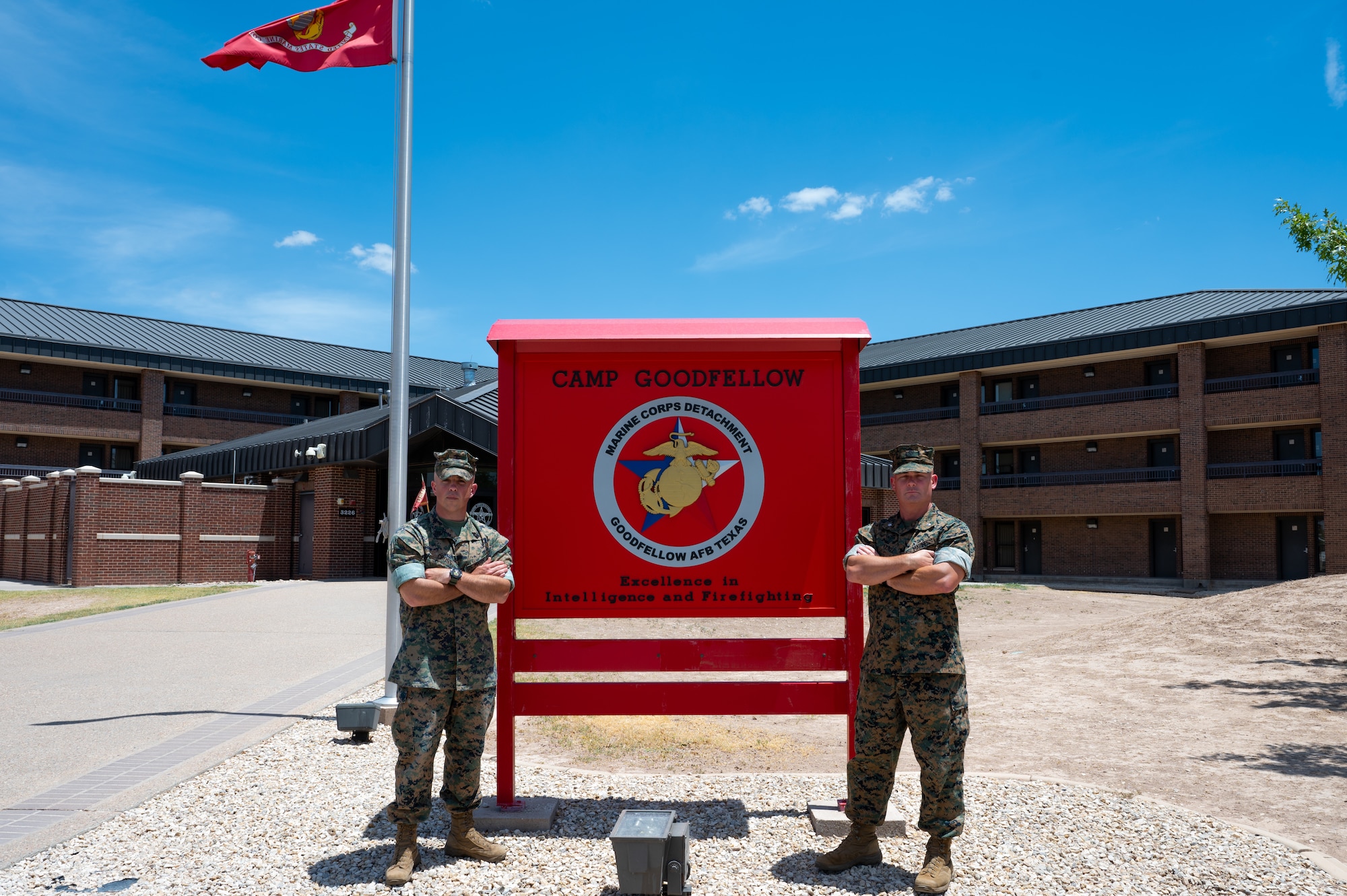 U.S. Marine Corps Master Gunnery Sgt. Darry Cross, Marine Corps Detachment Goodfellow senior enlisted advisor, and Lt. Col. Thomas Coyle, MCD Goodfellow commander, stand together in front of the Camp Goodfellow sign, Goodfellow Air Force Base, Texas, August 1, 2022. MCD Goodfellow consists of over 90 permanent party Marines responsible for facilitating training of multiple military occupational specialties. (U.S. Air Force photo by Senior Airman Michael Bowman)