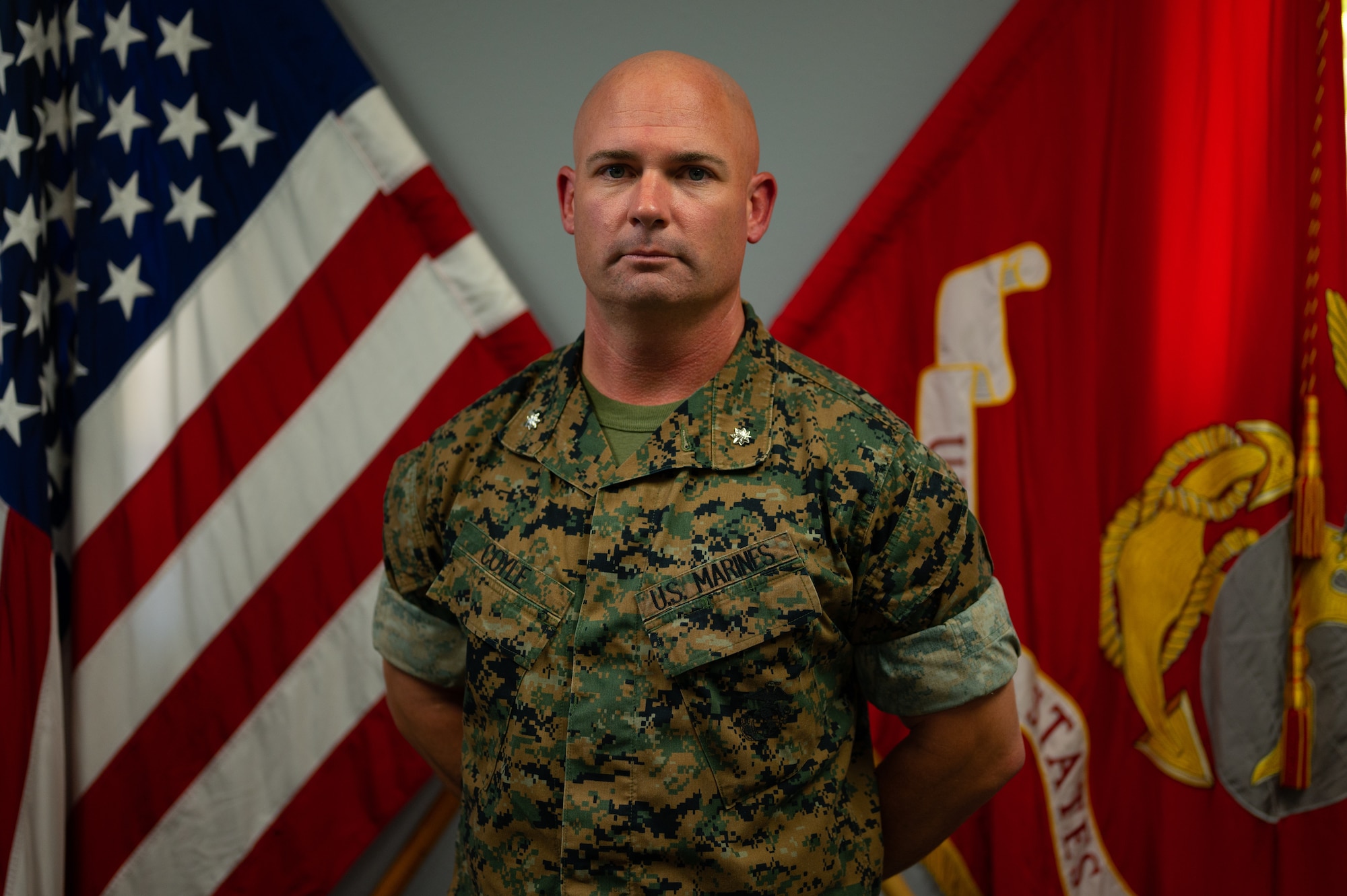 U.S. Marine Corps Lt. Col. Thomas Coyle, Marine Corps Detachment Goodfellow commander, poses for photo in front of the U.S. and U.S. Marine Corps flags, Goodfellow Air Force Base, Texas, August 1, 2022. As commander of MCD Goodfellow, Coyle oversees 92 permanent party Marines and facilitates the training of multiple military occupational specialties. (U.S. Air Force photo by Senior Airman Michael Bowman)