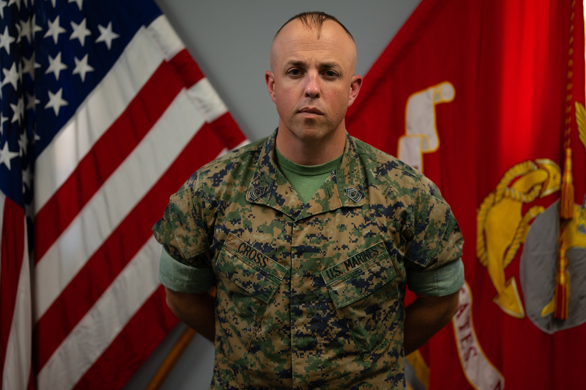 Master Gunnery Sgt. Darry Cross, Marine Corps Detachment Goodfellow senior enlisted advisor, poses for photo in front of the U.S. and U.S. Marine Corps flags, Goodfellow Air Force Base, Texas, August 1, 2022. Cross enlisted into the Marine Corps in 2003, graduating later that year from the Naval Technical Training Center as an electronic signals intelligence operator. (U.S. Air Force photo by Senior Airman Michael Bowman)