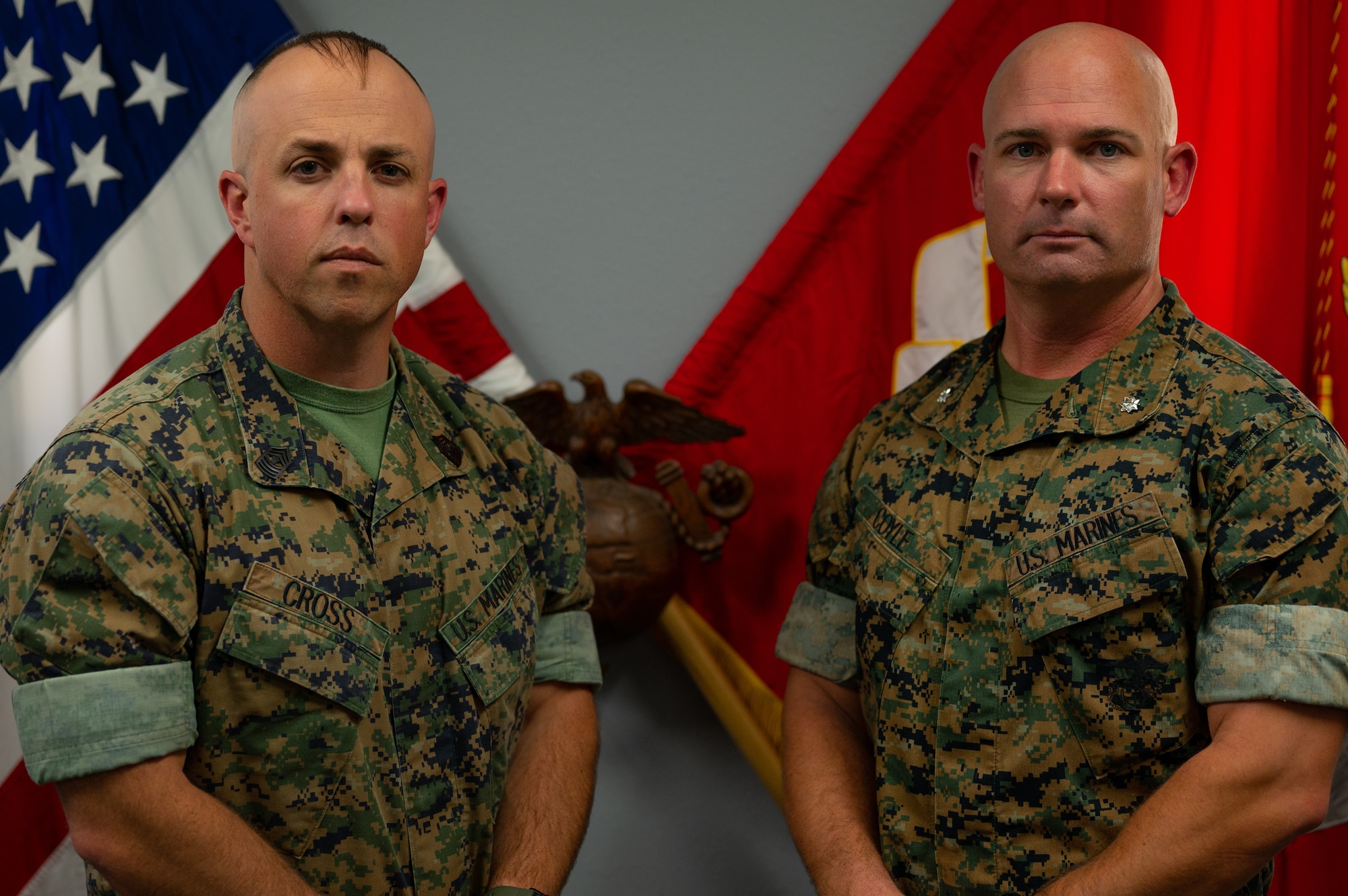 U.S. Marine Corps Master Gunnery Sgt. Darry Cross, Marine Corps Detachment Goodfellow senior enlisted advisor, and Lt. Col. Thomas Coyle, MCD Goodfellow commander, pose for a photo together in front of the U.S. and USMC flags, Goodfellow Air Force Base, Texas, August 1, 2022. The command team will lead the development of both students and staff, and proactively seek out opportunities to improve and optimize MCD Goodfellow training and instruction to maximize the quality of Marines they graduate to the fleet and supporting establishment. (U.S. Air Force photo by Senior Airman Michael Bowman)