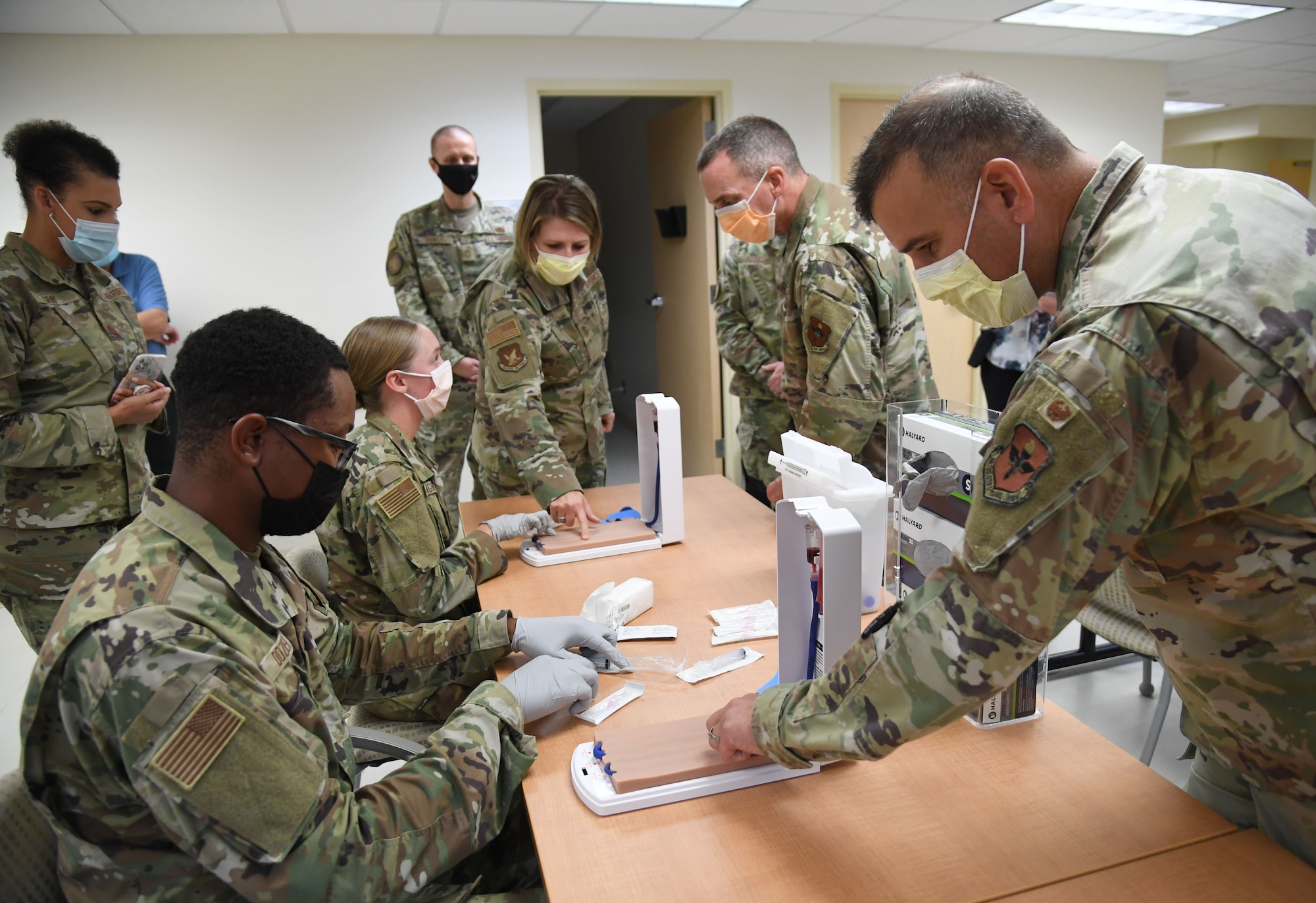 Members of the 81st Medical Group provide an IV training demonstration to Chief Master Sgt. Kathleen McCool, Second Air Force command chief, and Col. Nicholas Dipoma, Second Air Force vice commander, during an immersion tour inside the Keesler Medical Center at Keesler Air Force Base, Mississippi, July 29, 2022. The tour also included the 334th Training Squadron air traffic control simulator and the 81st Medical Group clinical research lab. (U.S. Air Force photo by Kemberly Groue)