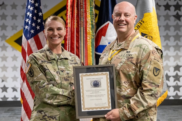 Col. Rebecca McElwain, U.S. Army Central assistant chief of staff G-8, presents Col. Ralph M. "Mac" Crum, U.S. Army Financial Management Command chief of staff, with a Maj. Gen. Nathan Towson Medallion at the Maj. Gen. Emmett J. Bean Federal Center in Indianapolis June 6, 2022. The Towson Medallion is named after Maj. Gen. Nathan Towson, who served as Paymaster General of the Army from 1819 to 1854 and shaped a Finance Corps that met the Army’s needs until the 20th century. (U.S. Army photo by Mark R. W. Orders-Woempner)
