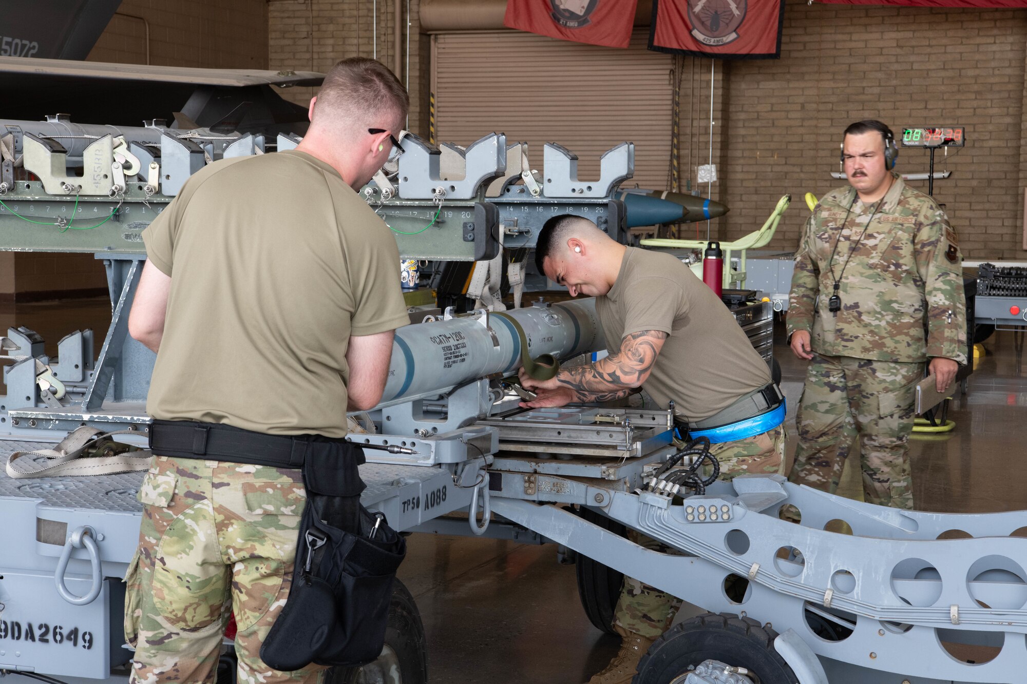 F-35 Lightning II maintainers load weapons onto an F-35 during a weapons load competition.