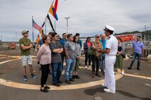 Lt. j.g. Andrew Middlebrooks, a communications officer assigned to the Arleigh Burke-class guided missile destroyer USS John Paul Jones (DDG 53), explains what a flight deck is to a tour group during Fleet Week, Aug. 2, 2022. Fleet Week Seattle is a time-honored celebration of the sea services and provides an opportunity for the citizens of Washington to meet Sailors, Marines and Coast Guardsmen, as well as witness firsthand the latest capabilities of today's maritime services. (U.S. Navy photo by Mass Communication Specialist 2nd Class Victoria Galbraith)