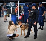 Maritime Enforcement Specialist 2nd Class Alesha Horn speaks with a child about military dog handling at pier 62, August 2 in support of Fleet Week Seattle 2022. Fleet Week Seattle is a time-honored celebration of the sea services that provides an opportunity for the citizens of Washington to meet Sailors, Marines and Coast Guardsmen, and witness the latest capabilities of today’s maritime services. (U.S. Navy photo by Mass Communication Specialist 2nd Class Aranza Valdez)