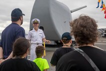 Ensign Will Lewis speaks to visitors during a tour aboard Ticonderoga-class guided missile cruiser USS Lake Champlain (CG 57) as part of Fleet Week Seattle, Aug. 2, 2022.  Fleet Week Seattle is a time-honored celebration of the sea services and provides an opportunity for the citizens of Washington to meet Sailors, Marines and Coast Guardsmen, as well as witness firsthand the latest capabilities of today's maritime services. (U.S. Navy photo by Mass Communication Specialist 2nd Class Ethan J. Soto)