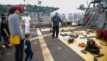 Damage Controlman 2nd Class Justin Diaz speaks to visitors during a tour aboard Arleigh Burke-class guided missile destroyer USS John Paul Jones (DDG 53) as part of Fleet Week Seattle, Aug. 2, 2022.  Fleet Week Seattle is a time-honored celebration of the sea services and provides an opportunity for the citizens of Washington to meet Sailors, Marines and Coast Guardsmen, as well as witness firsthand the latest capabilities of today's maritime services. (U.S. Navy photo by Mass Communication Specialist 2nd Class Ethan J. Soto)