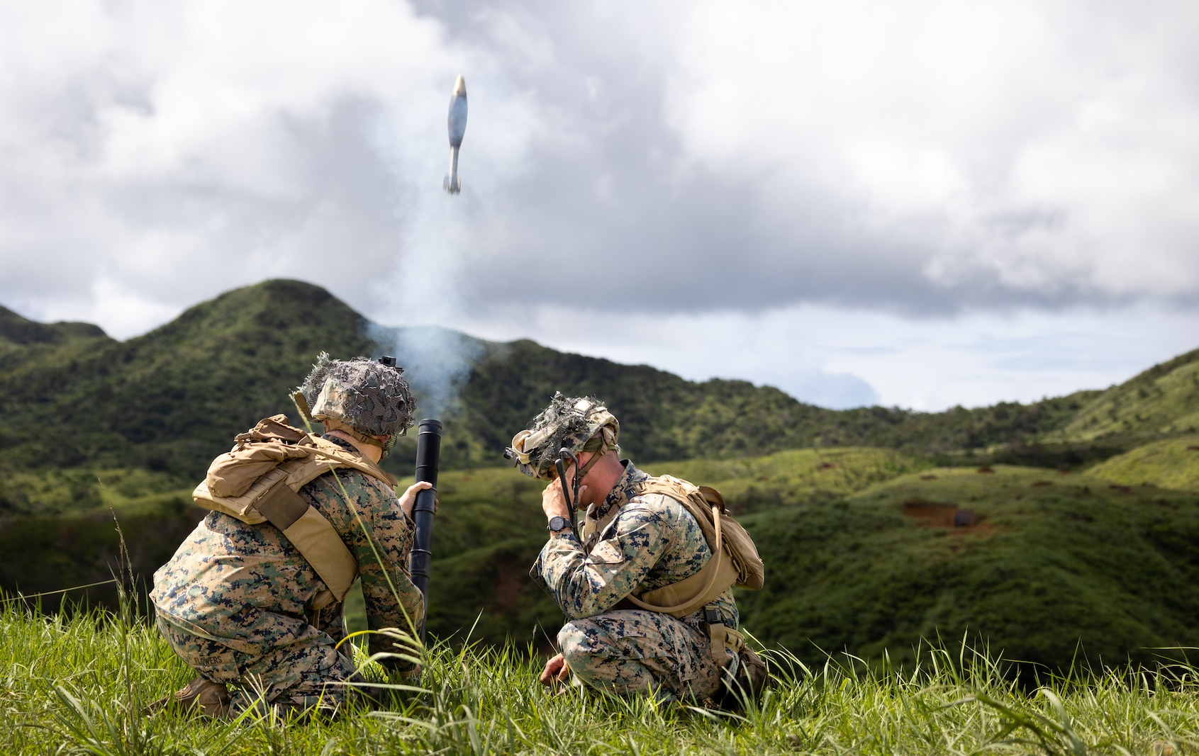 U.S. Marine Corps Lance Cpl. Joseph Flowers (left), an intelligence specialist, and Sgt. Andrew Licea (right), a mortar section leader, both with 3d Battalion, 3d Marines, fire an M224 60 mm mortar system while conducting squad attacks during a live-fire range at Camp Hansen, Okinawa, Japan, July 28, 2022. This training improved the Marines’ proficiency at the tactical level and developed small-unit leadership. 3/3 is forward deployed in the Indo-Pacific under 4th Marines, 3d Marine Division as part of the Unit Deployment Program. (U.S. Marine Corps photo by Sgt. Micha Pierce)