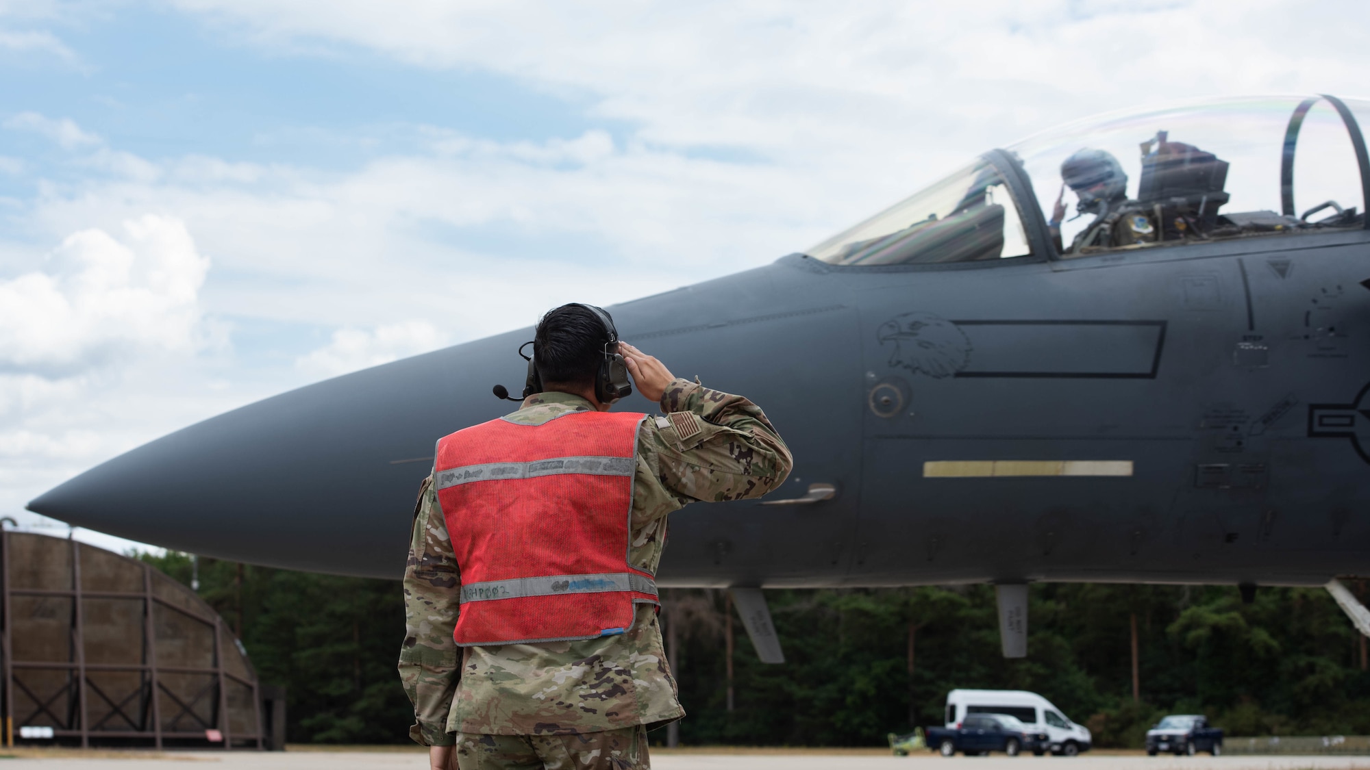 U.S. Air Force Tech. Sgt. Hector Gonzalez, 435th Contingency Response Squadron assistant flight chief of aircraft maintenance, salutes a pilot assigned to the 492nd Fighter Squadron at Royal Air Force Lakenheath, July 27, 2022. The training taking place gives the U.S. Air Force the ability to employ contingency response teams in support of combat assets in the European and African theaters. (U.S. Air Force photo by Airman Austin Salazar)