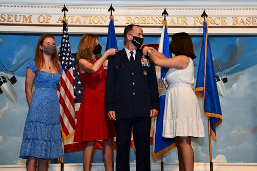 Lt. Gen. John Healy’s family pin his new rank on his uniform