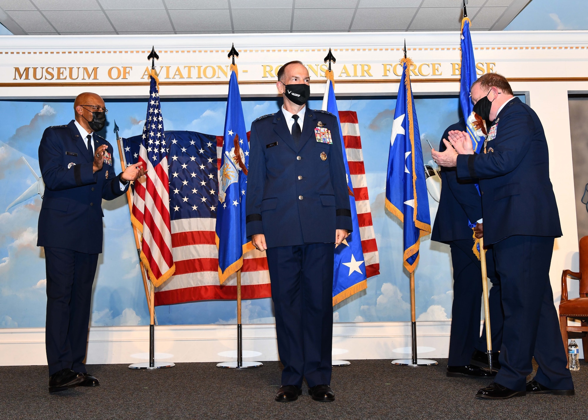 Lt. Gen. John Healy receives applause on stage after taking command of Air Force Reserve Command during a ceremony.