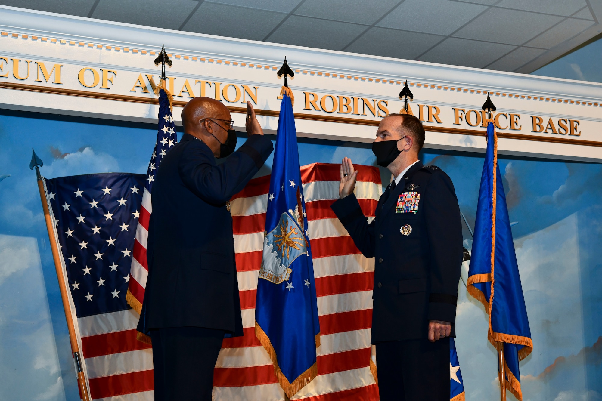 Air Force Chief of Staff Gen. CQ Brown, Jr., administers the oath of office to Lt. Gen. John Healy on stage