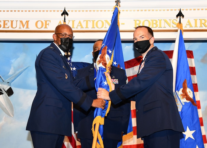 Lt. Gen. John Healy accepts the Air Force Reserve Command guidon from Air Force Chief of Staff Gen. CQ Brown, Jr. during a change of command ceremony