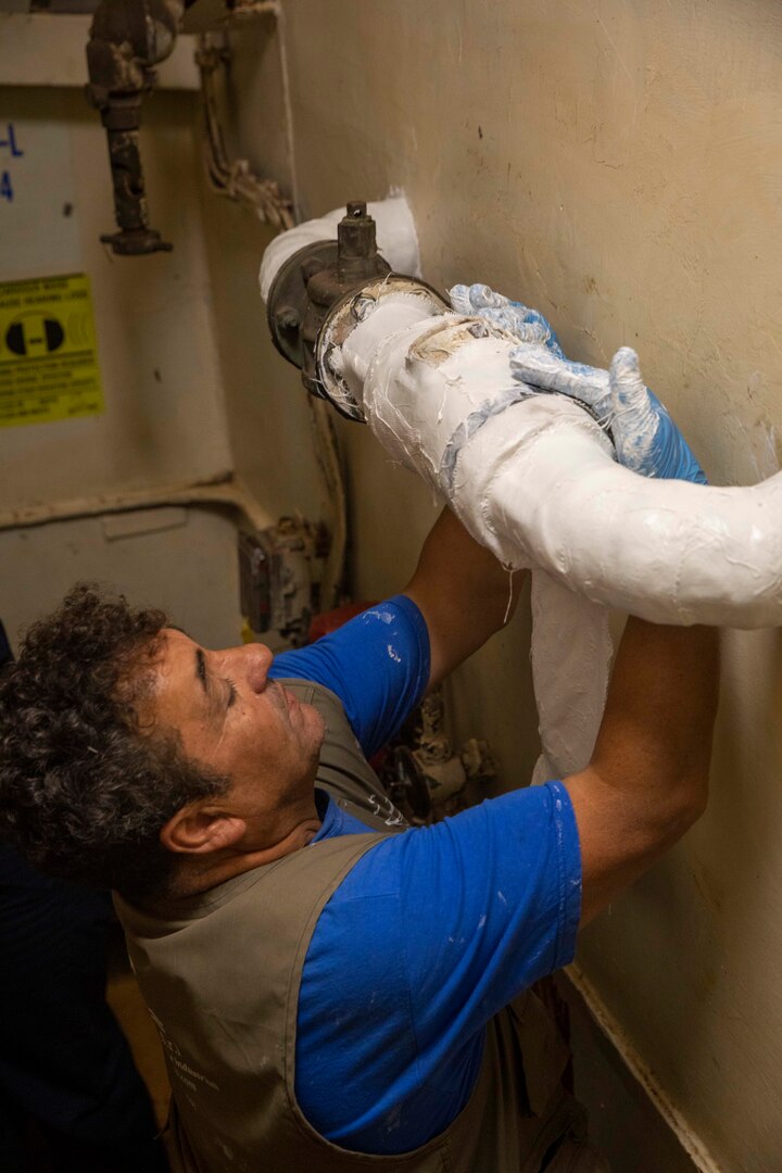 Pasquale Buono, a government contractor, performs maintenance aboard the Whidbey Island-class dock landing ship USS Gunston Hall (LSD 44) during mid-deployment voyage repairs, July 12, 2022.