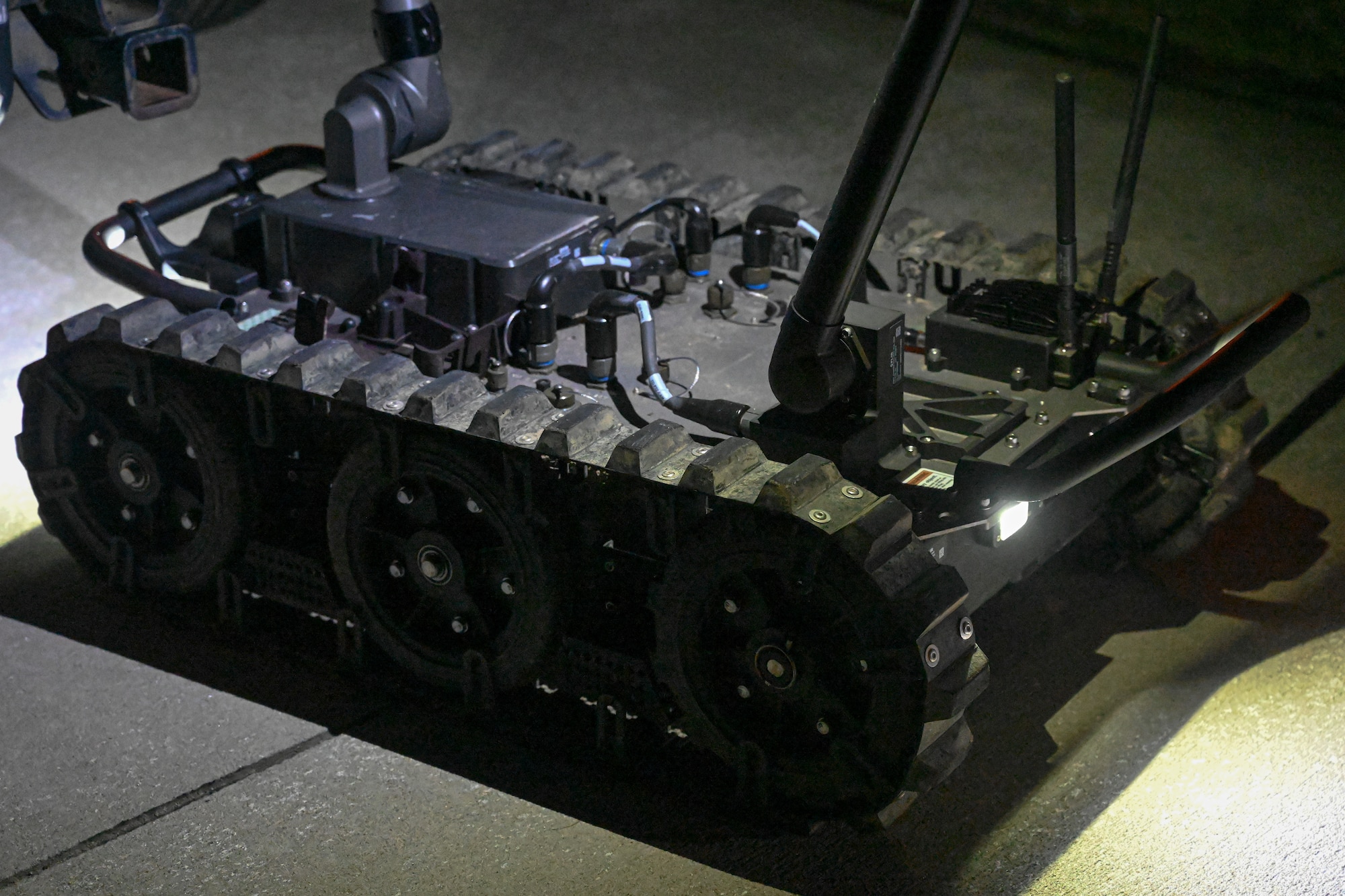 An EOD robot sits on the floor.