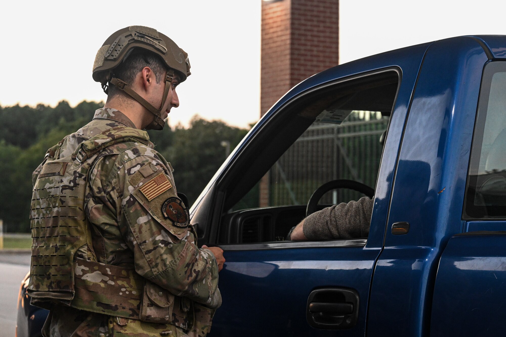 An Airman checks IDs at the gate.