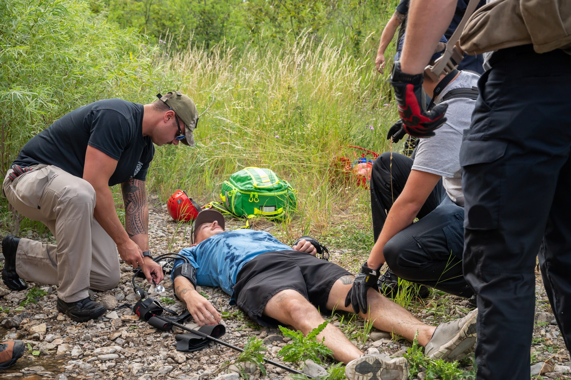 Members of the 341st Civil Engineer Squadron Fire Department respond to a simulated patient during a search and rescue exercise Aug. 2, 2022, in Sluice Boxes State Park, Mont.