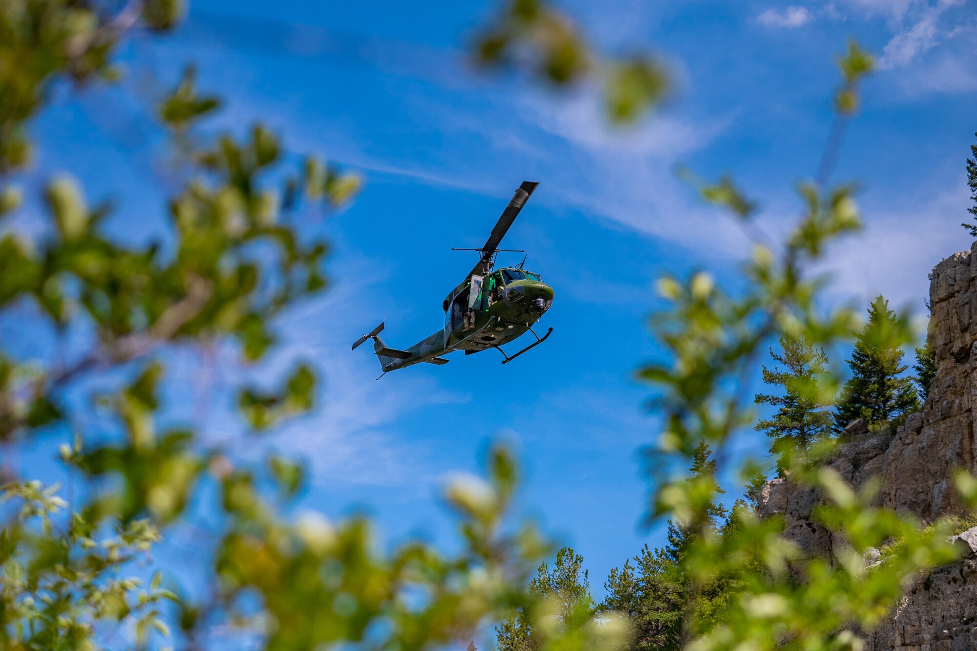 An UH-N1 Huey flies to the pick-up site during a search and rescue exercise August 3, 2022, in Sluice Boxes State Park.