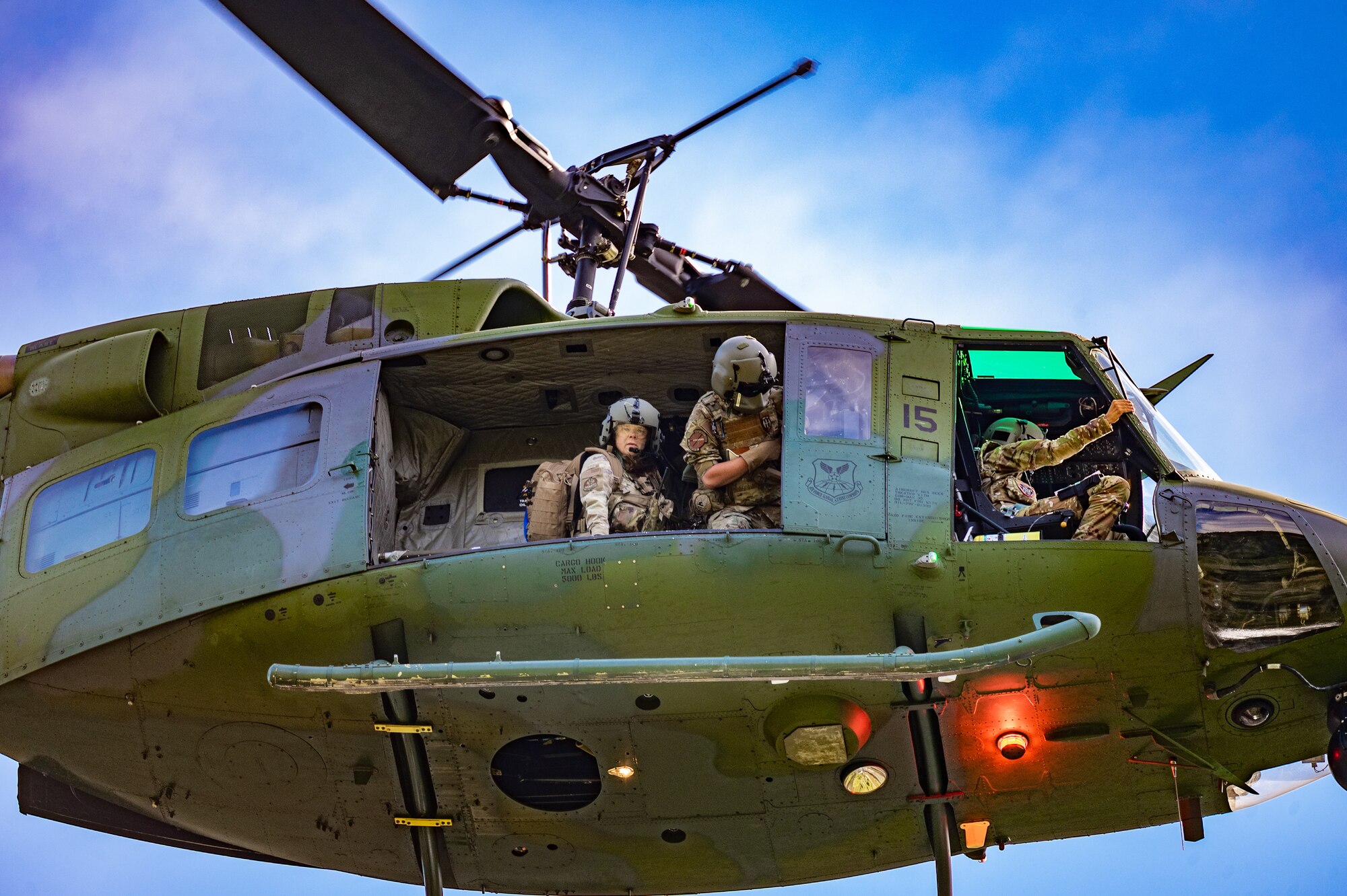 The aircrew of the 40th Helicopter Squadron prepare to lower an UH-N1 Huey to the pick-up site during a search and rescue exercise August 3, 2022, in Sluice Boxes State Park.
