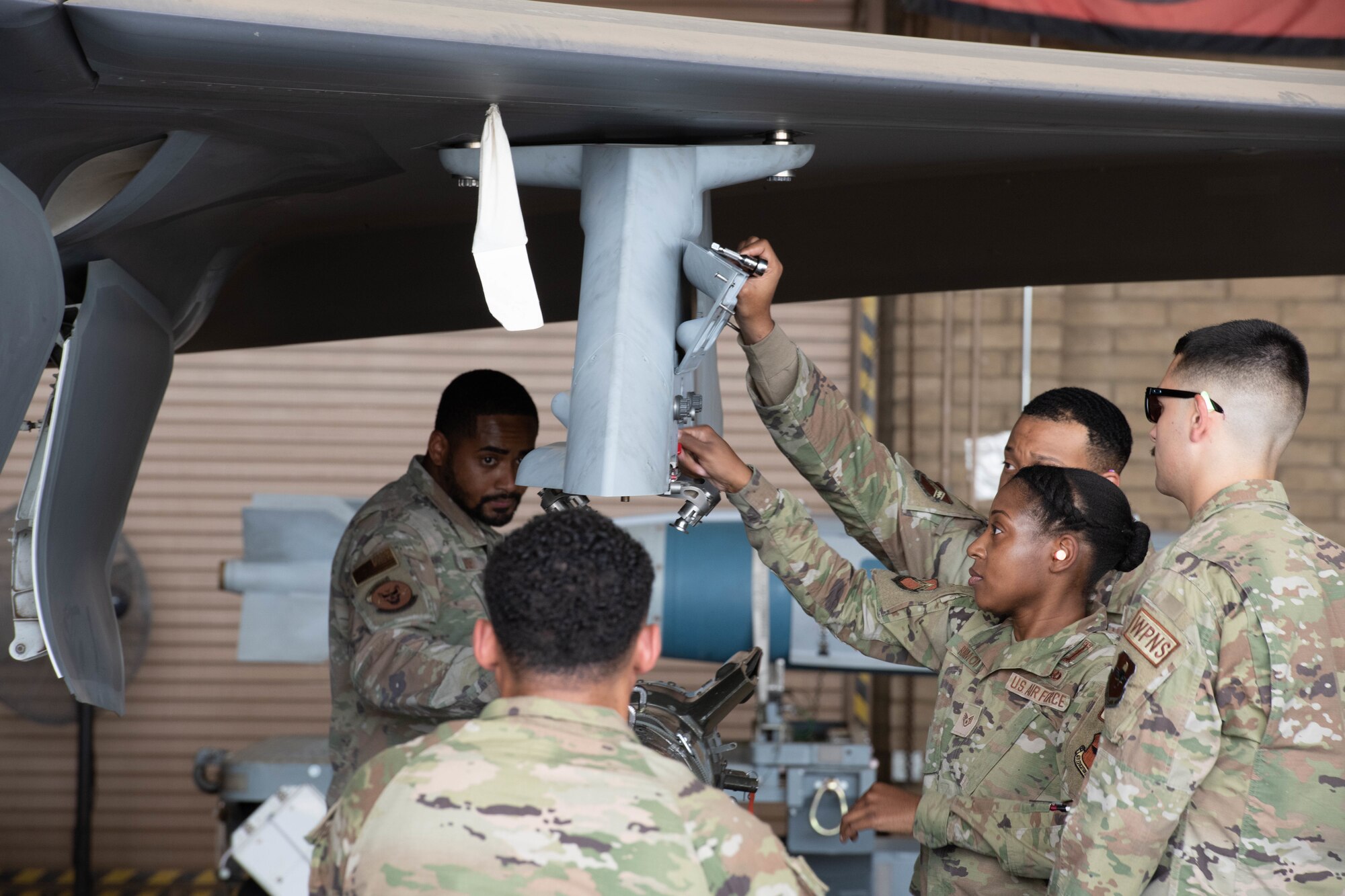 F-35 Lightning II maintainers load weapons onto an F-35 during a weapons load competition.