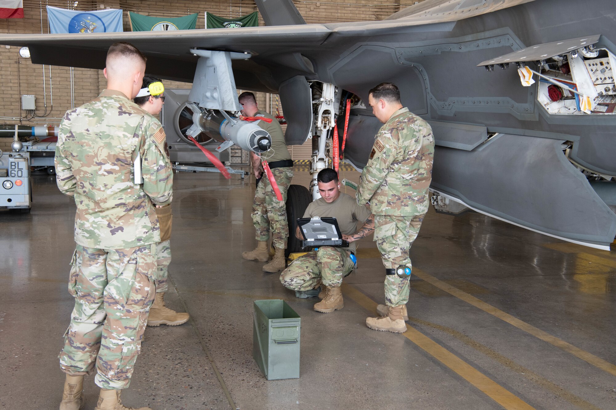 F-35 Lightning II maintainers load weapons onto an F-35 during a weapons load competition.