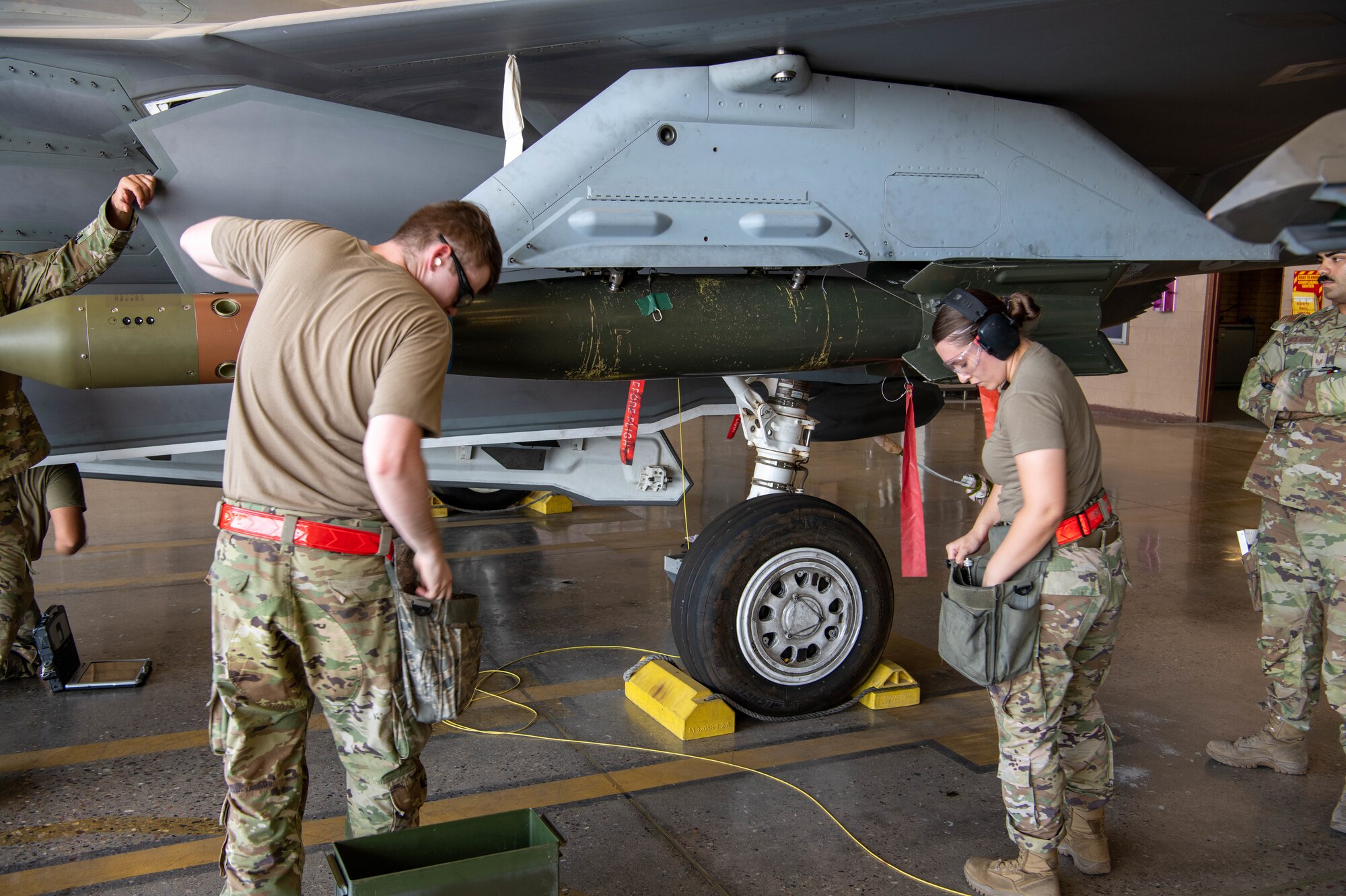 F-35 Lightning II maintainers load weapons onto an F-35 during a weapons load competition.