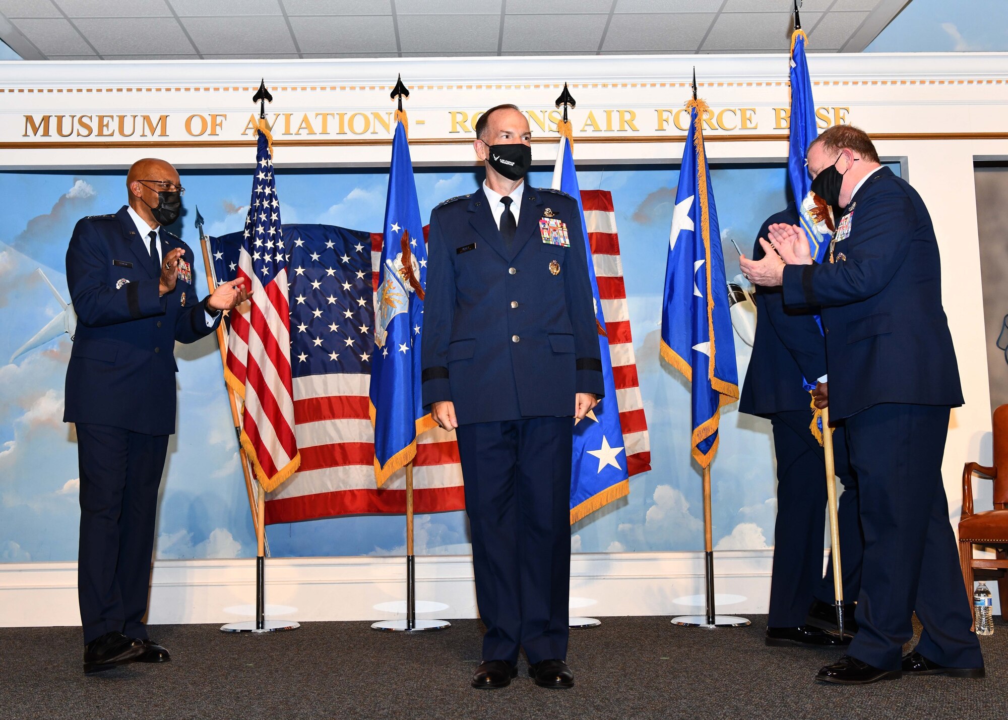 Lt. Gen. John Healy receives applause on stage after taking command of Air Force Reserve Command during a ceremony.
