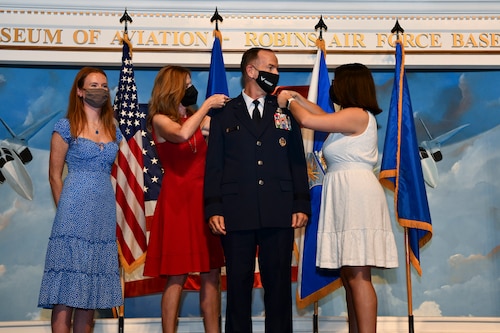 Lt. Gen. John Healy’s family pin his new rank on his uniform