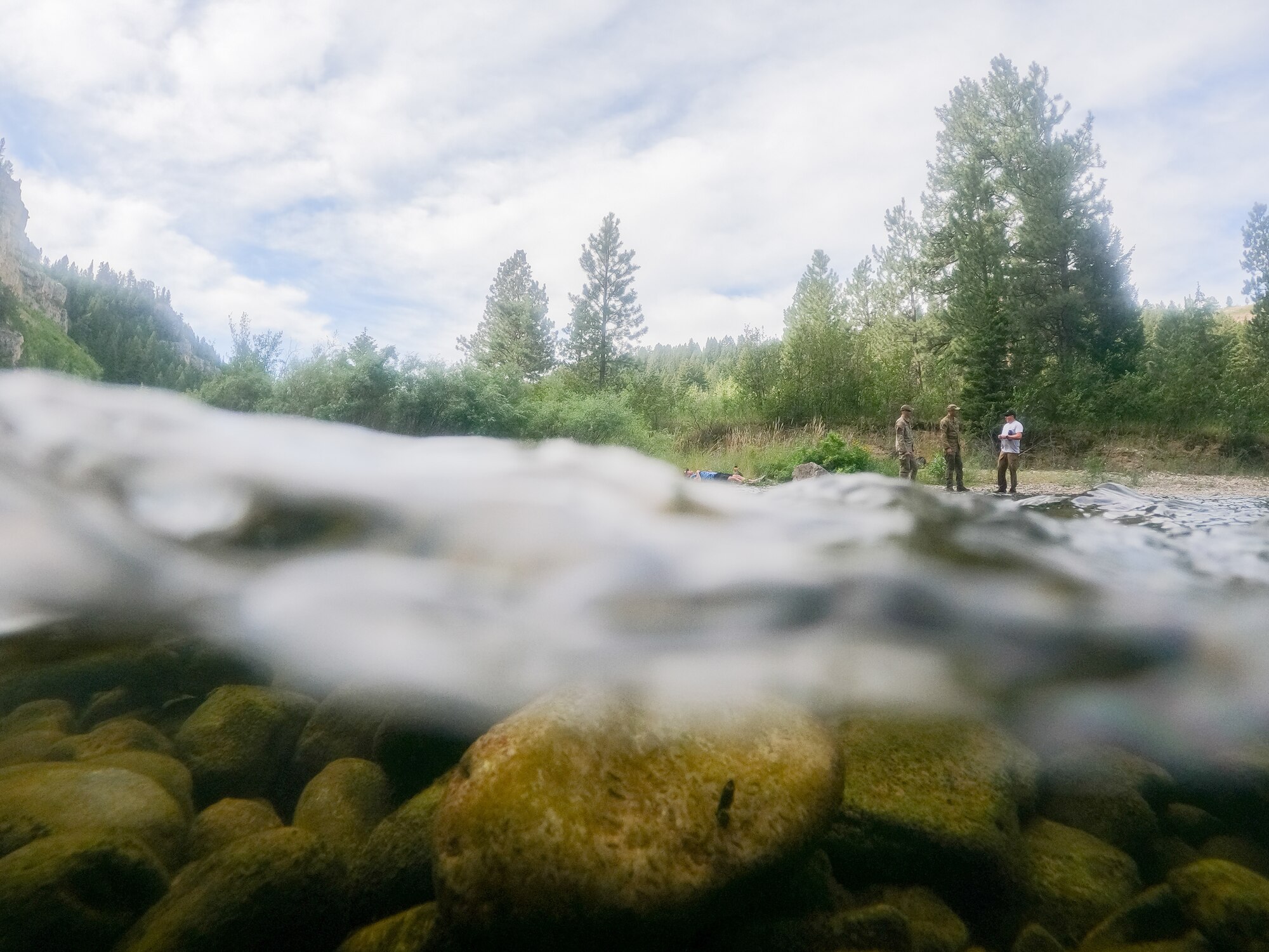 Malmstrom Air Force Base Airmen stand on the bank of Belt Creek before the start of a search and rescue exercise Aug. 2, 2022, in Sluice Boxes State Park, Mont.