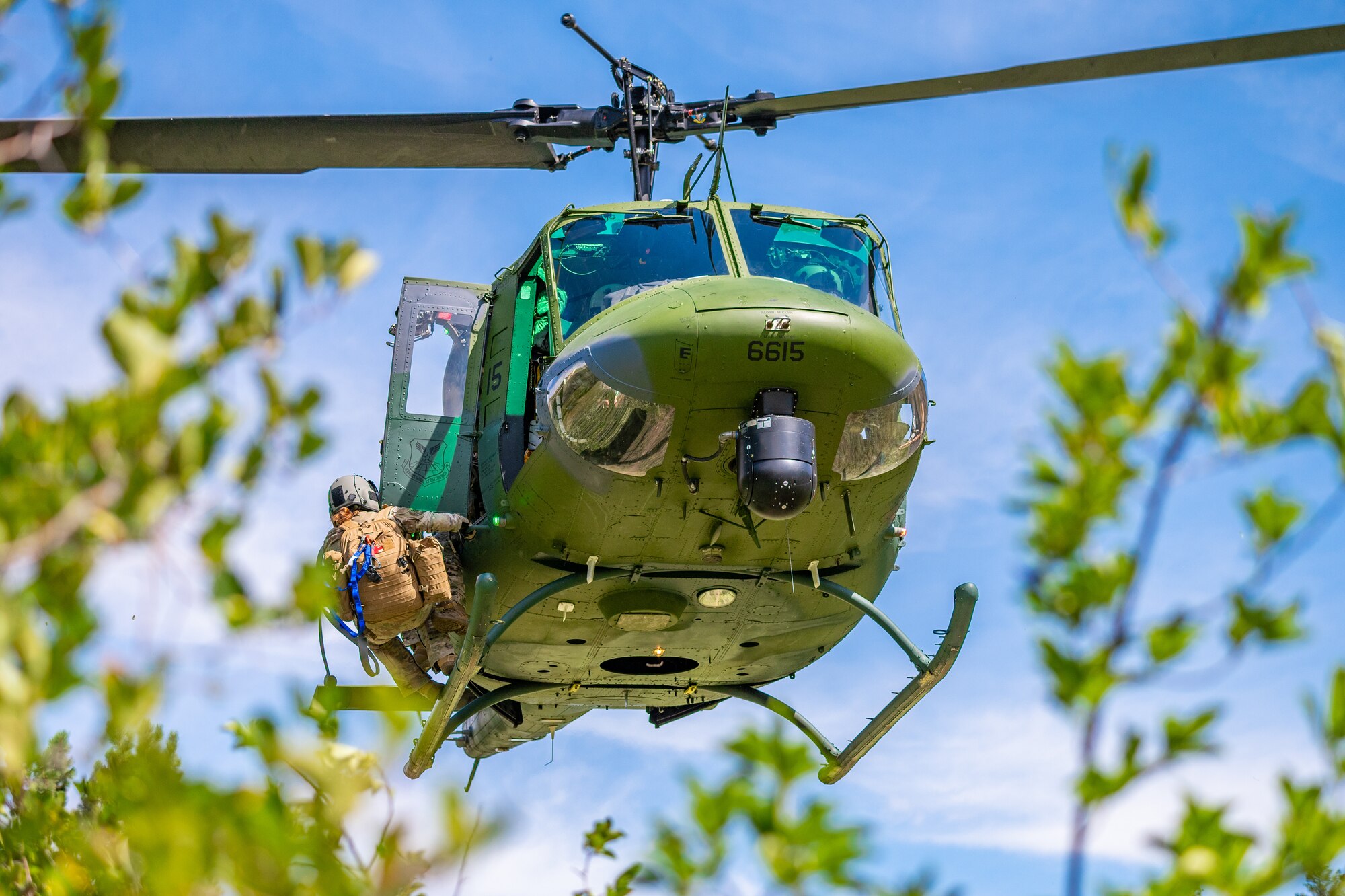 Maj. Joyanne Tesei, 341st Medical Group flight doctor, is hoisted into an UH-N1 Huey during a search and rescue exercise August 3, 2022, in Sluice Boxes State Park.