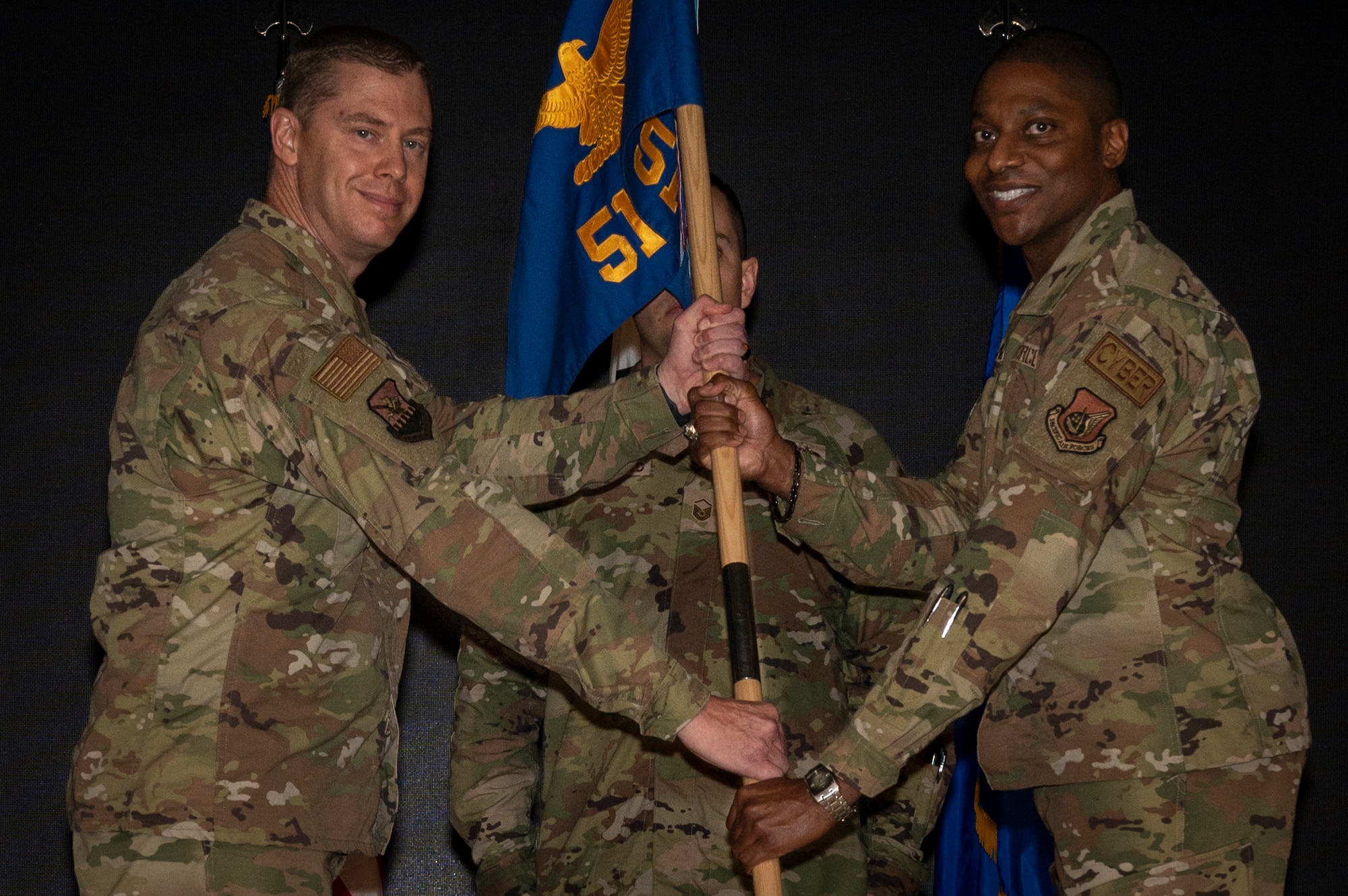 Col. Kyle Grygo, 51st Mission Support Group commander, passes the guidon to Lt. Col. Michael Newson, 51st Communications Squadron newly appointed commander during an assumption of command at Osan Air Base, Republic of Korea, Aug. 2, 2022.