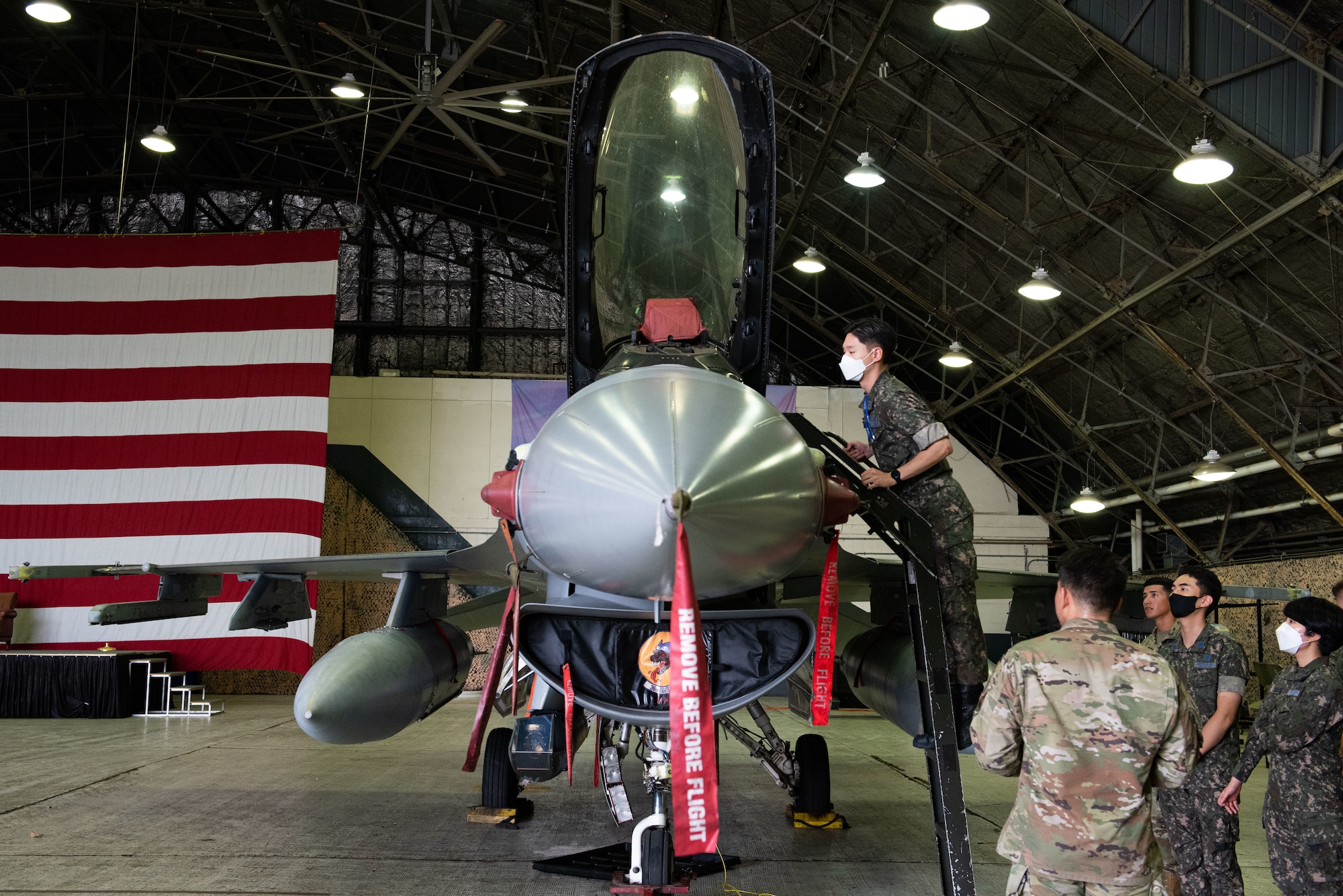 A Republic of Korea Air Force translator officer, looks inside an F-16 Fighting Falcon cockpit during an immersion tour at Osan Air Base, Republic of Korea, Aug. 2, 2022.