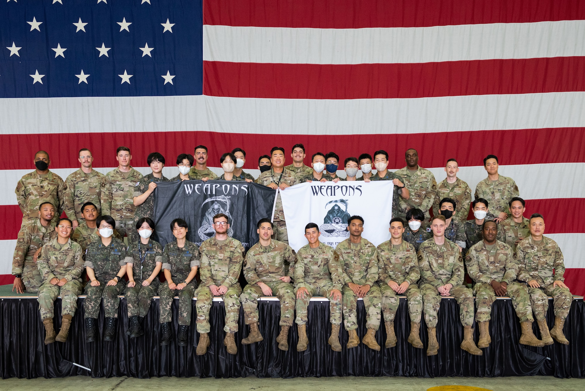 Team Osan Airmen and Republic of Korea Air Force translator officers, pose for a group photo during an immersion tour at Osan Air Base, Republic of Korea, Aug. 2, 2022.