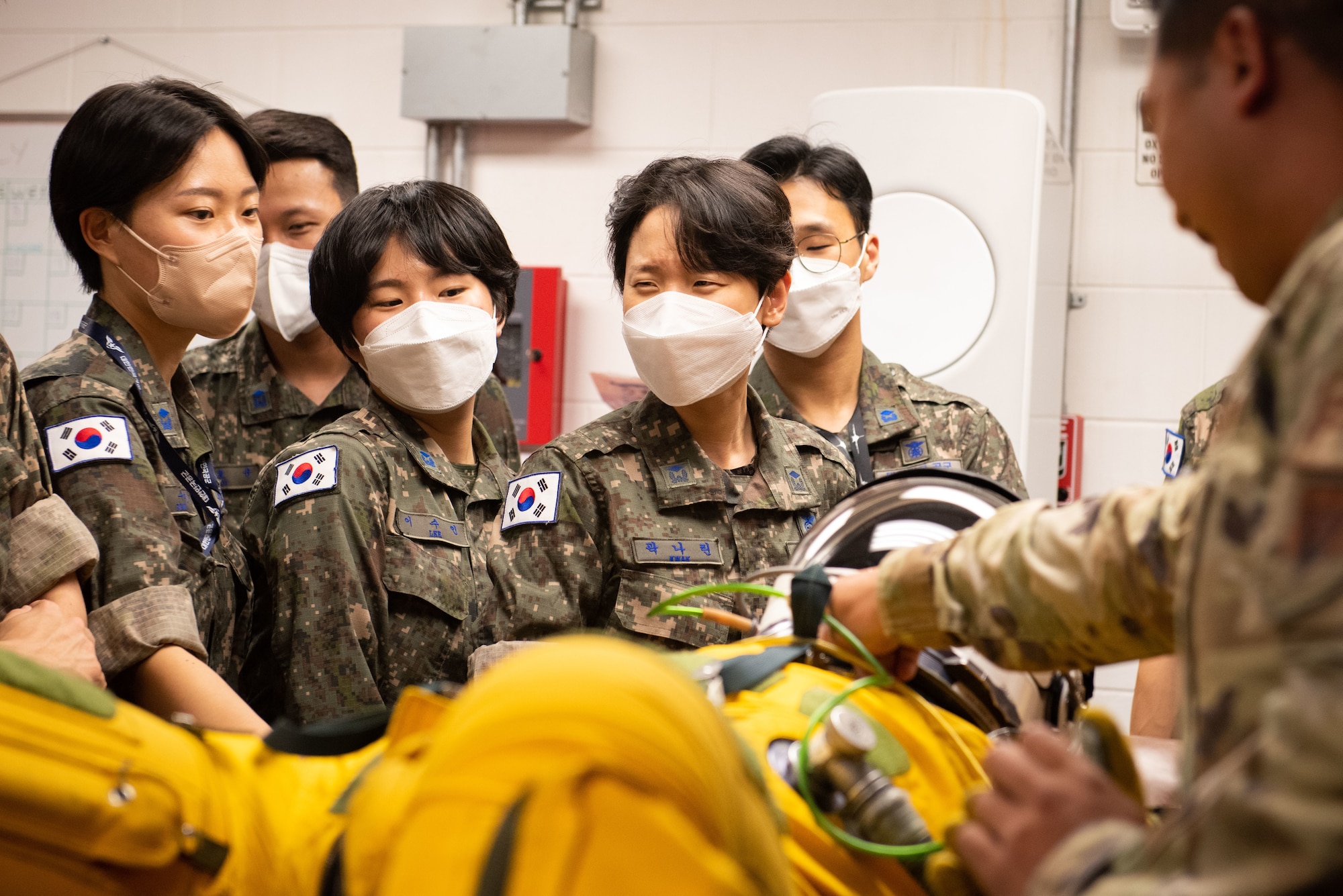 Republic of Korea Air Force translator officers are shown a U-2S Dragon Lady flight suit during an immersion tour at Osan Air Base, Republic of Korea, Aug. 2, 2022.