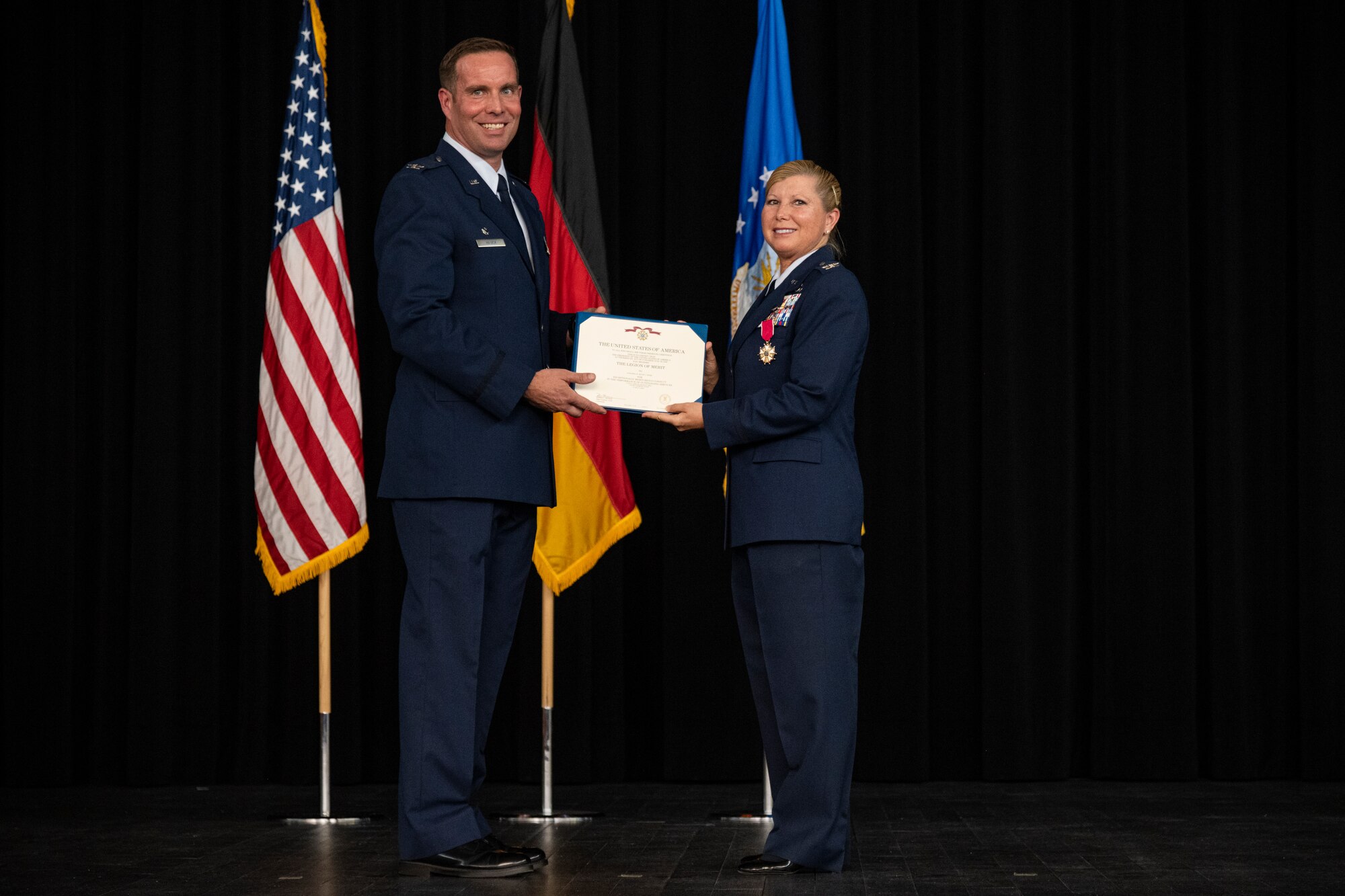 A military member receives a medal and certificate