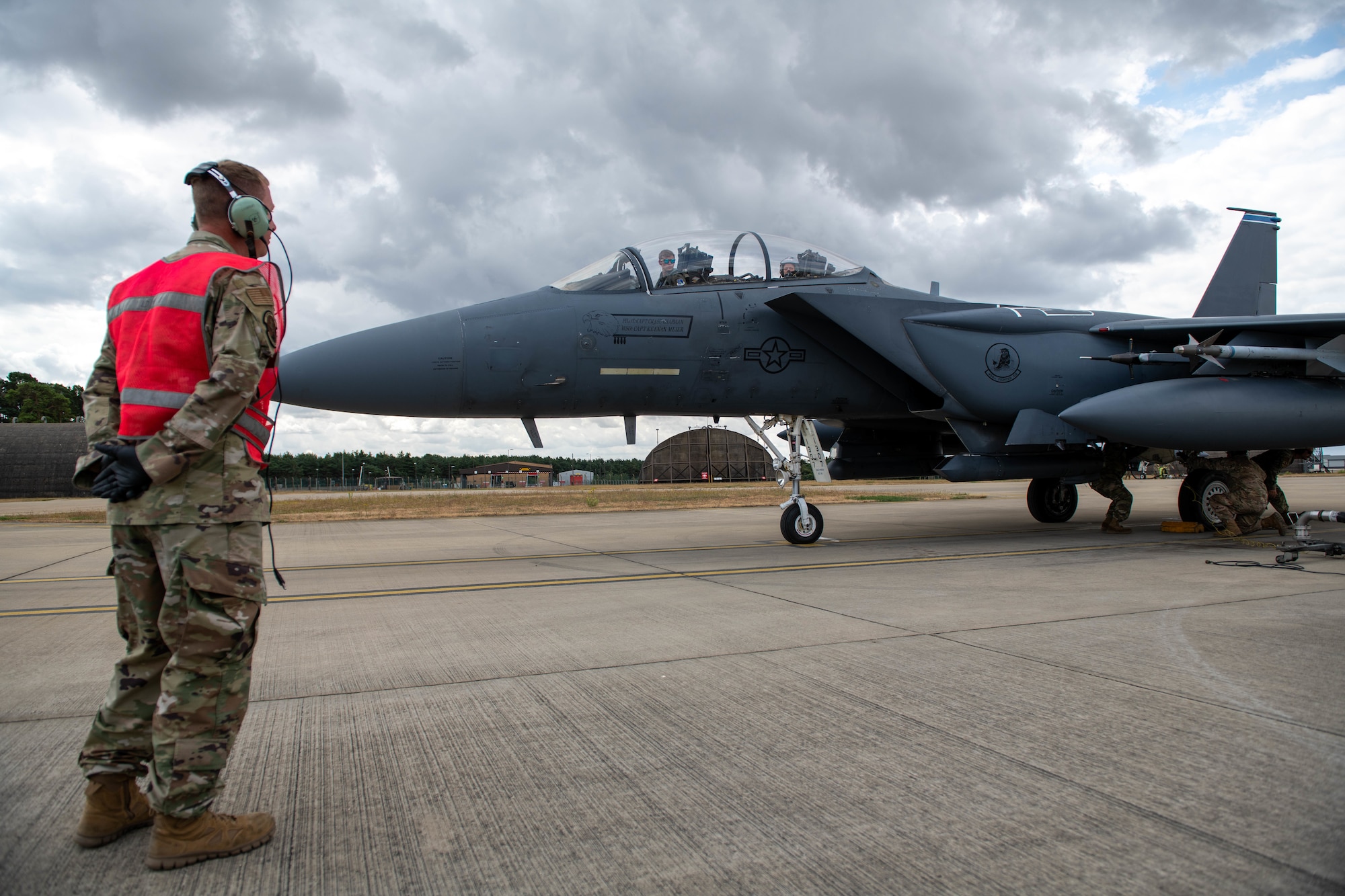 U.S. Air Force Master Sgt. Donavan Reid, 435th Contingency Response Squadron aircraft maintenance flight chief, performs hot-pit refueling training on an F-15E Strike Eagle at Royal Air Force Lakenheath, England, July 27, 2022. This training helps enhance U.S. Air Forces in Europe’s  employment capability of contingency response teams in support assets within the theater.(U.S. Air Force photo by Airman 1st Class Olivia Gibson)