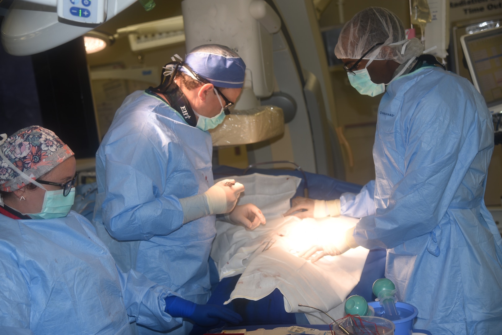 U.S. Navy Cmdr. (Dr.) Eric H. Twerdahl, a surgeon in the Division of Vascular Surgery and the current surgical quality officer at Walter Reed National Military Medical Center, perform surgery in one of WRNMMC's hybrid operating rooms on July 14.
