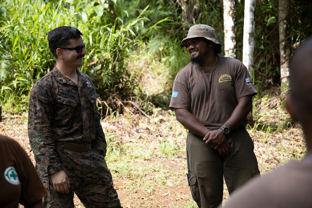 U.S. Marine Corps Sgt. Sebastian VillaGomez, an explosive ordnance technician with Task Force Koa Moana 22, I Marine Expeditionary Force, and Scarly Renguul, a searcher with the Norwegian People's Aid, prepare for the first day of an Explosive Effects Range in Babeldaob, Republic of Palau, June 27, 2022. Named “Koa Moana,” after a Hawaiian/Polynesian phrase meaning “ocean warrior,” the task force fosters peace and security, builds relationships, and supports an international rules-based order that benefits the Indo-Pacific region.