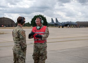 U.S. Air Force Master Sgt. Donavan Reid, 435th Contingency Response Squadron aircraft maintenance flight chief, and a 48th Maintenance Group quality assurance inspector, perform hot-pit refueling training on a F-15E Strike Eagle at Royal Air Force Lakenheath, England, July 27, 2022. This training helps enhance U.S. Air Forces in Europe’s  employment capability of contingency response teams in support assets within the theater. (U.S. Air Force photo by Airman 1st Class Olivia Gibson)
