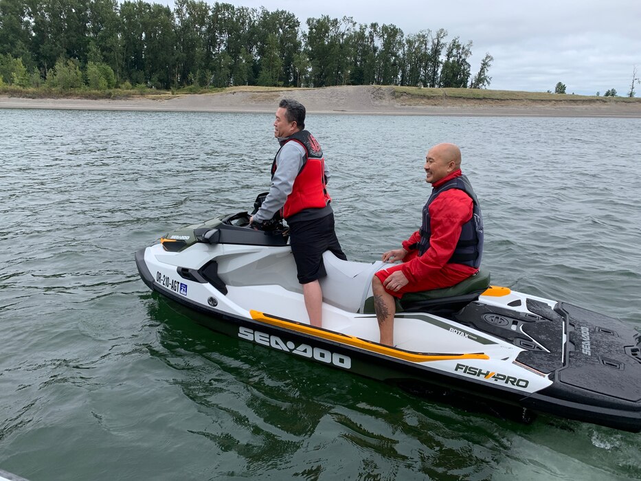 Two men sit on a jet ski in the Columbia River