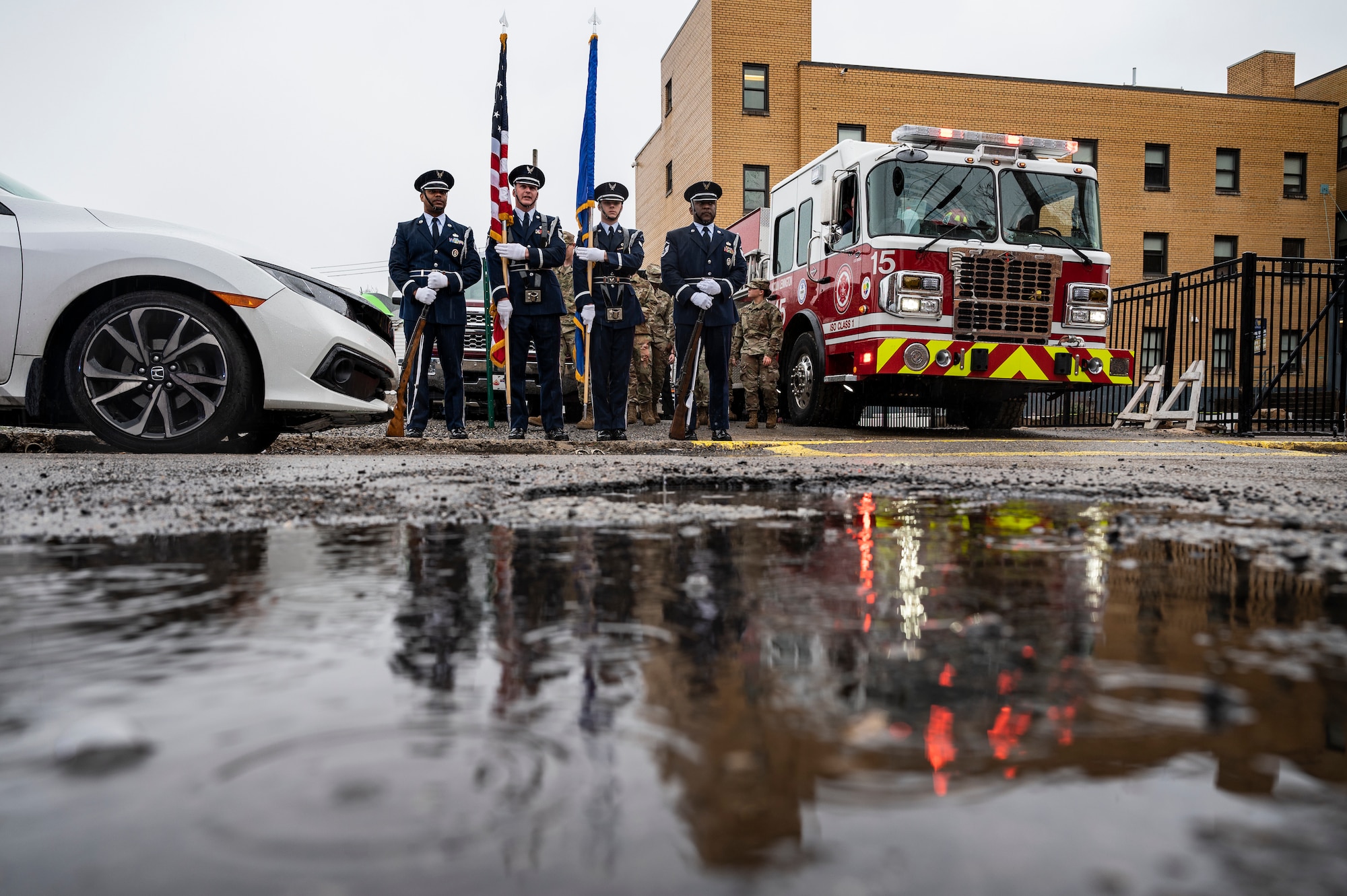 Airmen assigned to the 911th Airlift Wing Honor Guard and members from the City of Pittsburgh Bureau of Fire prepare for a parade in front of the house of Joseph Wilbon, a World War II veteran, in Pittsburgh, Pennsylvania, April 11, 2022.