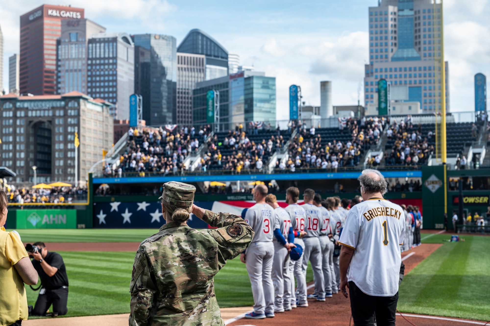 Tech. Sgt. Vanessa Norris, a readiness NCO assigned to the 911th Airman and Family Readiness Center renders a salute during the singing of the National Anthem before the Pittsburgh Pirates home opener at PNC Park in Pittsburgh, Pennsylvania, April 12, 2022.