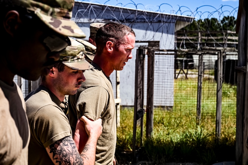 A U.S. Army National Guard Soldier assigned to the 340th Military Police company simulates the in-processing of a detainee as part of a simulated exercise on Joint Base McGuire-Dix Lakehurst, N.J., July 30, 2022. Soldiers from the 333rd MP Brigade, 340th MP Battalion gathered here for Gotham Justice, a four-week exercise that trained, challenged and improved Soldiers’ primary skill sets and core MP competencies required in detention operations and security and mobility support operations. (U.S. Air Force photo by Senior Airman Matt Porter)